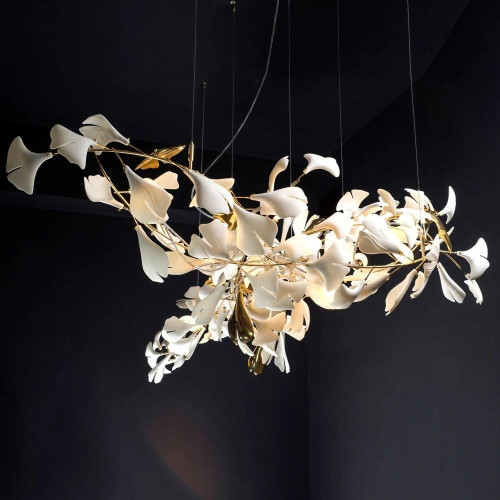 Introducing the Elara White Porcelain Lamp: A Luxurious Leaf Shaped Designer White Porcelain Pendant Light , a true masterpiece that exudes elegance and sophistication. This stunning chandelier features a meticulously crafted gold frame adorned with exquisite white porcelain leaves, creating a mesmerizing focal point in any space. The delicate leaf-shaped porcelain pieces add a touch of nature-inspired beauty, while the gold frame accentuates its luxurious appeal.

With its timeless design and impeccable craftsmanship, the Elara Chandelier is a perfect choice for those seeking to elevate their interior decor. Whether placed in a high-end restaurant, a refined dining room, or a luxurious hotel lobby, this chandelier effortlessly enhances the ambiance and creates a captivating atmosphere. The warm glow emanating through the porcelain leaves casts a gentle radiance, adding a sense of enchantment to any setting.

Indulge in the allure of the Elara Chandelier and embrace its opulent presence. With its impeccable design, meticulous attention to detail, and captivating beauty, this chandelier is a true testament to exquisite craftsmanship and refined taste. Elevate your space with the Elara Chandelier and let its timeless elegance become the centrepiece of your interior decor.