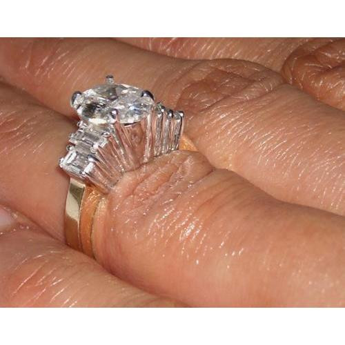 oval diamond engagement ring, antique style diamond ring, two-tone gold engagement ring, VS1 clarity diamond ring, F color diamond jewelry, 1.51 carat diamond ring, oval and baguette diamond ring, natural earth-mined diamonds, fine jewelry craftsmanship, bespoke engagement ring, vintage-inspired diamond ring, collector’s diamond jewelry, high jewelry engagement ring, 14K yellow and white gold ring, sophisticated diamond engagement ring