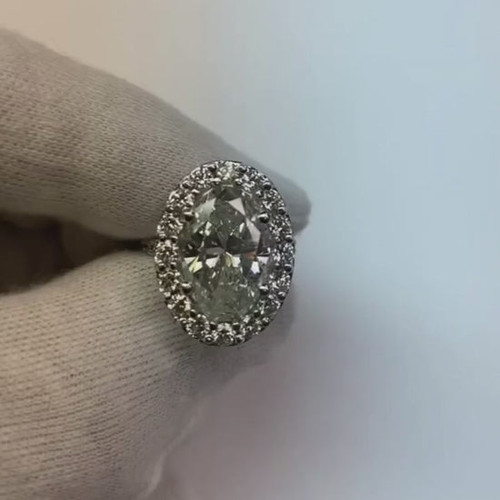 oval diamond halo ring, 7.50 carat diamond ring, luxury wedding jewelry, VS1 oval diamond ring, VVS1 diamond halo ring, G color diamond jewelry, high jewelry engagement ring, investment grade diamond ring, bespoke diamond halo ring, fine oval cut diamond ring, 14K white gold diamond ring, natural earth-mined diamond, collector's diamond jewelry, prestigious bridal jewelry, sophisticated diamond engagement ring, exclusive diamond wedding ring, certified high-value diamond ring, superior clarity diamond halo ring