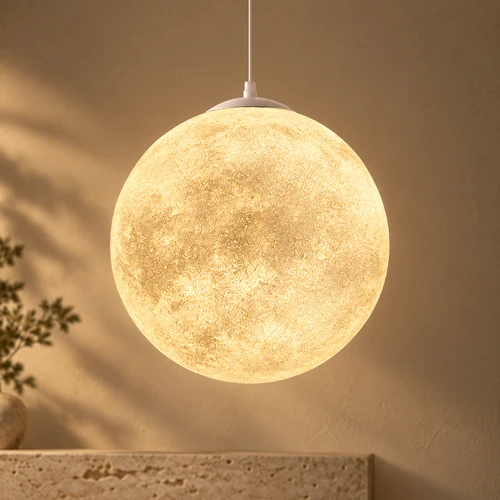 Luna moon pendant light with a textured globe shade glowing warm white, suspended against a soft neutral backdrop.