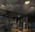Industrial multi arm ceiling light showing full structure with extended arms and balanced lighting coverage across a wide space.