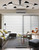 Mid-century multi arm ceiling light installed in a large living space, providing balanced ambient and directional illumination.