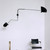 Mid-century wall light installed in a modern interior, providing both ambient and task lighting.