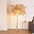 A feather palm tree floor lamp infuses your space with a tropical oasis vibe. The palm tree silhouette, embellished with delicate feathers, exudes a sense of exotic beauty. It casts a soft, inviting glow through the feathers, transporting you to a serene and enchanting coastal paradise right in your own home.