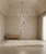 Murano glass chandelier, multicolored crystal chandelier, luxury staircase chandelier, artisan glass lighting, bespoke Venetian chandelier, high ceiling statement light, colorful blown glass fixture, modern luxury interior lighting, upscale foyer chandelier, designer multi-colored chandelier, custom Italian glass art, architectural lighting design, high-end residential decor, luxury hospitality lighting, contemporary cascading chandelier, vibrant glass pendant light, grand entrance hall lighting, 