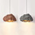 This stone pendant lamp is a unique and eye-catching addition to any room. The natural rock finish adds texture and depth, while the sleek modern design keeps it contemporary. The lamp casts a warm and inviting glow, making it perfect for creating a cozy ambiance in any space. The lamp is versatile and can be used as a standalone piece or in a group to create a more dramatic effect. It is perfect for modern or rustic interiors, and the warm light will complement any décor. The pendant lamp is a statement piece that will be sure to impress, making it a great choice for those who want to add a touch of unique style to their home or workspace.