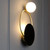 Elevate your interior with Vida's Black and Gold Ultra Modern Wall Lights. Combining sleek black finishes with luxurious gold accents, these fixtures exude contemporary elegance. Their minimalist design and innovative aesthetics make them perfect for modern spaces seeking a touch of sophistication. Whether adorning living rooms, bedrooms, or hallways, these wall lights serve as striking focal points, illuminating your space with style and flair. With their sleek silhouette and practical functionality, Vida's Black and Gold Ultra Modern Wall Lights add a touch of luxury and modernity to any interior, creating an ambiance that's both chic and inviting.