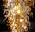 double-height ceiling, hotel stairway chandelier, upscale interior, luxury residence, penthouse lighting, commercial lighting, monumental chandelier, fine art lighting, luxury hotel decor, grand entrance, entry foyer lighting, prestigious design, timeless elegance, opulent lighting, upscale home decor, modern organic chandelier, large-scale lighting, dramatic lighting, luxury architectural elements, high-end residential design, bespoke glass art, sculptural lighting