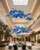 Naola Cobalt Blue Glass Commercial Atrium Lighting Installation
A dramatic view of the Naola cobalt blue glass chandelier suspended within a luxury shopping centre atrium. The sculptural arrangement of blue and aqua glass spheres creates a striking contemporary focal point for high-ceiling retail spaces, commercial foyers and multi-level architectural interiors.