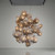 Studio professional photoshoot of the Athen statement chandelier, captured against a clean, neutral minimalist backdrop. The high-end architectural suspension light fixture is showcased from multiple angles, highlighting its intricate hand-formed metal branching armature and detailed brass wire mesh pods. Close-up shots emphasize the delicate texture of the woven clusters and the warm, ambient glow of the internal filament light sources, presenting the bespoke art piece with crystal-clear commercial lighting.