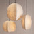 hallway fixture, coffee table lighting, breakfast bar light, corner accent, bedside hanging lamp, multi-light cluster, staggered installation, vertical profile, low-profile pendant, large sphere pendant, compressed oval pendant, elongated oval pendant, interior architecture, home renovation, spatial design, styling inspiration, cozy retreat, rustic charm, subtle tonal variations, premium fabric, durable frame, matching suspension cord, standard ceiling mount, long-lasting performance, warm neutral palette, fibrous finish, handmade paper look, architectural lines,