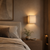 Kanso Japandi Wall Light in Minimalist Bedroom Setting
Close-up of the Kanso Japandi wall light installed beside a bed in a warm minimalist bedroom, featuring its layered louvered shade, soft G9 illumination and calming Japanese Wabi Sabi aesthetic.