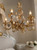luxury nursery lighting, ornamental gold lamp, antique floral chandelier, vintage chic lighting, high-end classic decor, graceful branch chandelier, porcelain flower ceiling light, charming vintage fixture, opulent interior lighting, opulent home decor, historic style hanging lamp, luxury antique light, dramatic ballroom chandelier, refined traditional lighting