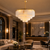 Ottavia Marble Chandelier in High-End Hotel Lobby
The Ottavia natural marble chandelier featured in a luxurious hotel lobby with marble finishes, elegant lounge seating and warm hospitality lighting. Its tiered stone design and gold frame create a striking focal point for premium reception and lounge areas.