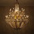 candle style chandelier, high ceiling lighting, double height ceiling light, statement lighting piece, majestic chandelier, opulent home decor, historic style lighting, Victorian revival lighting, Edwardian elegance light, palatial lighting fixture, luxury interior design, ornate gold chandelier, shimmering crystal drops