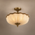 Élodie 60cm French Neoclassical Pleated Fabric Ceiling Light – Antique Brass Semi Flush
Élodie French Neoclassical semi-flush ceiling light, featuring a softly illuminated pleated ivory fabric shade, elegant scalloped trim and ornate antique-brass detailing. A refined 60cm statement ceiling light for luxury bedrooms, Parisian-style interiors, period homes, boutique hotels and French château-inspired spaces.