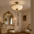 Élodie Pleated Fabric Ceiling Light in French Dressing Room
The Élodie 60cm French Neoclassical ceiling light illuminating a refined dressing room with gilt mirror, marble-topped vanity, classical furniture and warm neutral décor for a sophisticated period-inspired interior.