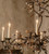 crystal beaded light, amber crystal accents, antique bronze finish, dark metal chandelier, luxurious hallway decor, high-end hallway design, luxury interior styling, upscale residential decor, grand architectural lighting, statement piece lighting, sophisticated design elements, classic luxury lighting, antique bronze light fixture, traditional candelabra light, medieval luxury decor