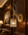 Scotland Gold Stag Wall Light on Dark Wood Panelling.
The Scotland gold stag wall light shown from an angled perspective against rich brown timber panelling in a luxurious library-style interior. The sculpted deer head, ornate gold backplate and crystal drops create a warm statement feature against the deep wood tones.