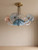 Aerys chandelier, pastel blue chandelier, handblown glass lighting, Murano style ceiling light, designer brass chandelier, luxury living room lighting, 90cm decorative pendant, vintage blue home decor, bespoke glass art fixture, contemporary luxury lighting, artisanal ceiling lamp, modern Italian chandelier, custom blown glass fixture, high-end interior design, elegant home lighting, statement chandelier, architectural lighting design, luxury living room decor, library lighting ideas, pastel aesthetic decor, gold and blue interior, artisan glass lighting, luxury hallway lighting, premium ceiling fixture, luxury home accessories, modern vintage chandelier