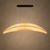 The Nami 150cm large Wabi Sabi fabric pendant light shown in a refined high-end product setting, highlighting its wide sculptural crescent form, softly gathered textile shade and warm diffused glow. Designed for Japandi dining rooms, kitchen islands, luxury homes, restaurants, boutique hotels and contemporary hospitality interiors.
