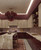 dramatic ceiling pendant, custom drop chandelier, oversized designer light fixture, artisanal Italian lighting style, burgundy glass cluster light, stacked glass bubble fixture, red glass tier chandelier, transitional luxury lighting, warm brass and burgundy glass, high-end architectural lighting, sculptural art glass pendant, luxury condo lighting, penthouse statement lighting, designer boutique lighting, luxury interior architectural element, handcrafted wine red art glass, modern organic lighting design, artistic statement ceiling lamp, luxury home decor lighting, high ceiling dining light, grand staircase lighting fixture