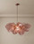 Dachi chandelier, luxury chandelier, Murano-style chandelier, rose quartz petal lighting, gilded brass chandelier, high end interior design, designer ceiling light, modern organic chandelier, custom brass pendant, luxury kitchen lighting, living room statement fixture, bespoke lighting design, architectural ceiling fixture, luxury home decor, designer chandelier, artisan crafted lighting, contemporary brass chandelier, organic luxury decor, high-end residential lighting, luxury hospitality lighting, statement ceiling light, multi-tiered chandelier, pink glass light fixture, gold and pink chandelier, modern rustic chandelier