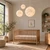 Three warm glowing Luna moon pendant lights in 25cm, 40cm and 60cm diameters, hanging at staggered heights above an oak crib in a neutral nursery.