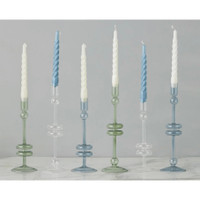 Six elegant glass candlesticks in varying heights, colors, and designs, holding white and blue taper candles.