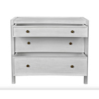 White hand-carved mahogany Hampton side table with three open drawers and metal pulls.