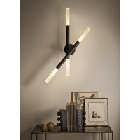 Modern black Cass Wall Sconce with four rotating arms and frosted acrylic diffusers, illuminating a dark room.