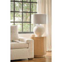 Arlo white ceramic table lamp with rounded base and natural linen shade on a wood side table.