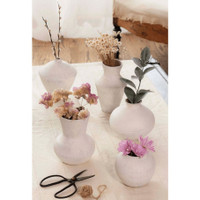 Five organic white handmade ceramic vases, varying in size and shape, with dried flowers and greenery.
