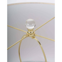 Close-up of a Stowe crystal table lamp with a polished brass spider and clear crystal finial.