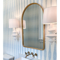 Hope Sculptural Wall Sconce with complex curves, matte white finish, and linen shade, flanking a gold mirror.