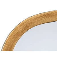 Close-up of a brass Aurora Wavy Wall Mirror, showing the hand-finished metal frame and unique waved edge.