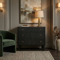 Daryl pale black ribbed mahogany dresser with three drawers and metal pulls, in a rustic industrial setting.