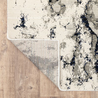 Evolution Contemporary Rug, ivory, charcoal & black, with a corner folded to show woven polypropylene backing.