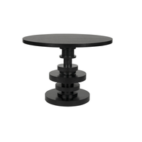 Corum round mahogany dining table with hand-rubbed black finish and stacked pedestal base.
