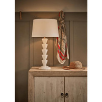 Patricia Jade Table Lamp with a white linen shade and natural jade stone base featuring stacked cone shapes.