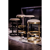Dior counter stools with black steel and antique brass bases, linen seats, and circular metal band design.