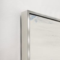 Close-up of Free Falling III Giclee Canvas Painting with blue brushstrokes, silver floating frame, and white wall.