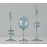 Sky blue glass wine glass vase with sphere top, flanked by two matching candlestick holders.