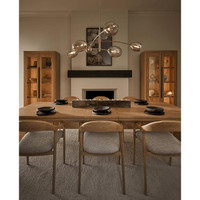 Artemis polished nickel chandelier with six open-ended Champagne glass globes over a dining table.