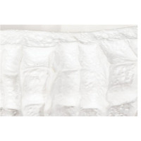 Close-up of a white ceramic bowl with unique, dramatic ridged texture.