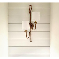 Bimini Double Sconce with natural woven seagrass, looped detailing, and two white linen shades on a white shiplap wall.