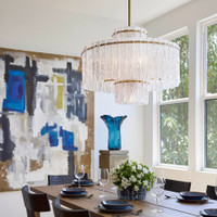 Orinder 9-light aged brass chandelier with hand-pressed textured glass panels, illuminating a dining room.