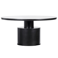 Marlow round black steel dining table with a minimalist design and sturdy cylindrical base.