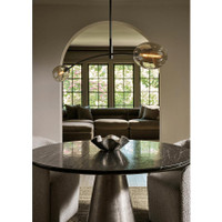 Small Pedicoat metal bowl with ruffled edges and metallic sheen on a dark round table.
