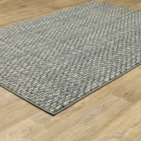 Seneca Blue & Ivory Casual Rug with modern organic geometric design on a wood floor.